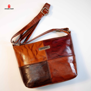 Genuine leather patchwork crossbody bag in brown tones with zip closure.