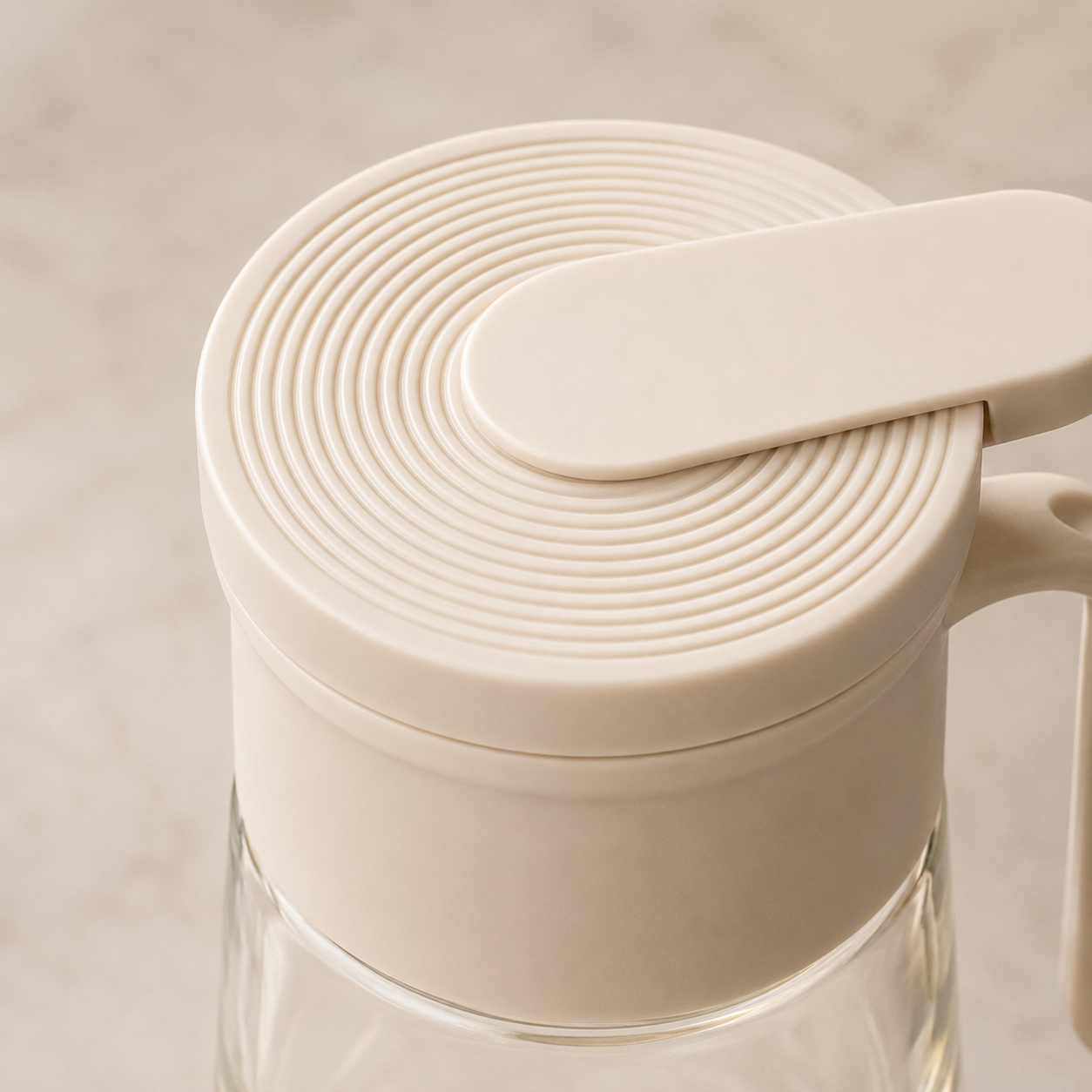 Close-up of Glass Oil Dispenser Bottle with Handle showing textured flip-top lid design, durable construction, and premium kitchenware detailing.