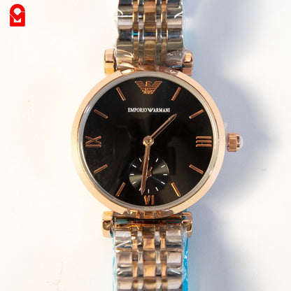 Close-up of women’s gold automatic watch showing black dial and small seconds sub dial.