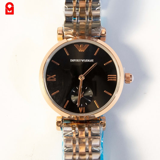 Close-up of women’s gold automatic watch showing black dial and small seconds sub dial.