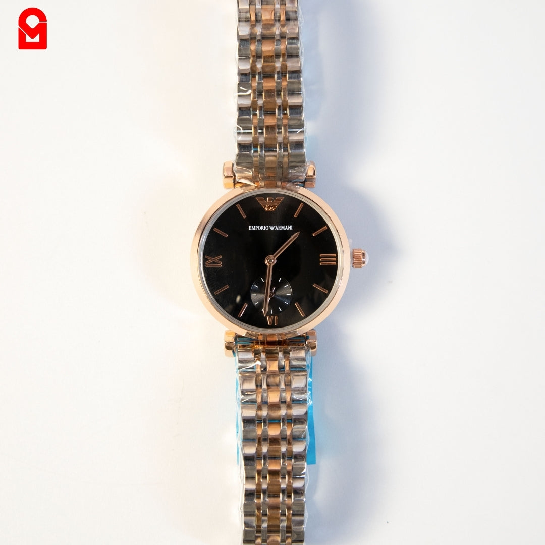 Gold and black automatic luxury watch for women with stainless steel bracelet on white background.