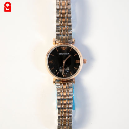 Gold and black automatic luxury watch for women with stainless steel bracelet on white background.