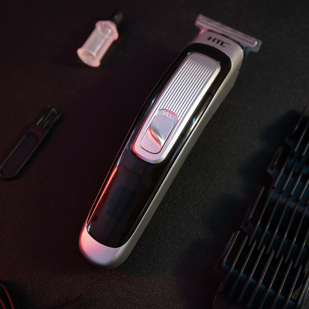 Rechargeable T-Blade Hair Trimmer for Men with guide comb attachments cleaning brush and lubricating oil flat lay setup