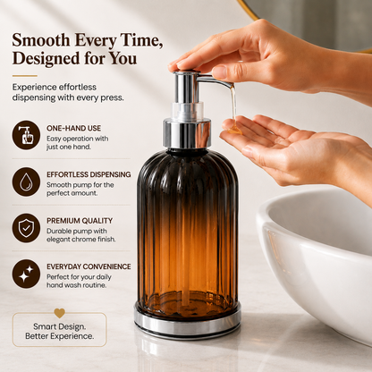 Hand pressing Hand Wash Storage Dispenser Bottle with amber transparent body and chrome pump dispenser on modern bathroom sink countertop