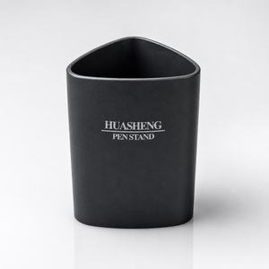 Black Huasheng Pen Stand with a rounded triangular design and smooth matte finish, displayed on a clean white studio background for office, study and home desk organization.