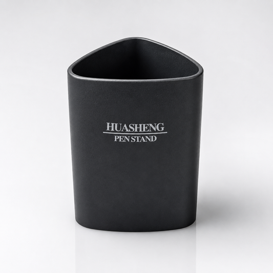 Black Huasheng Pen Stand with a rounded triangular design and smooth matte finish, displayed on a clean white studio background for office, study and home desk organization.