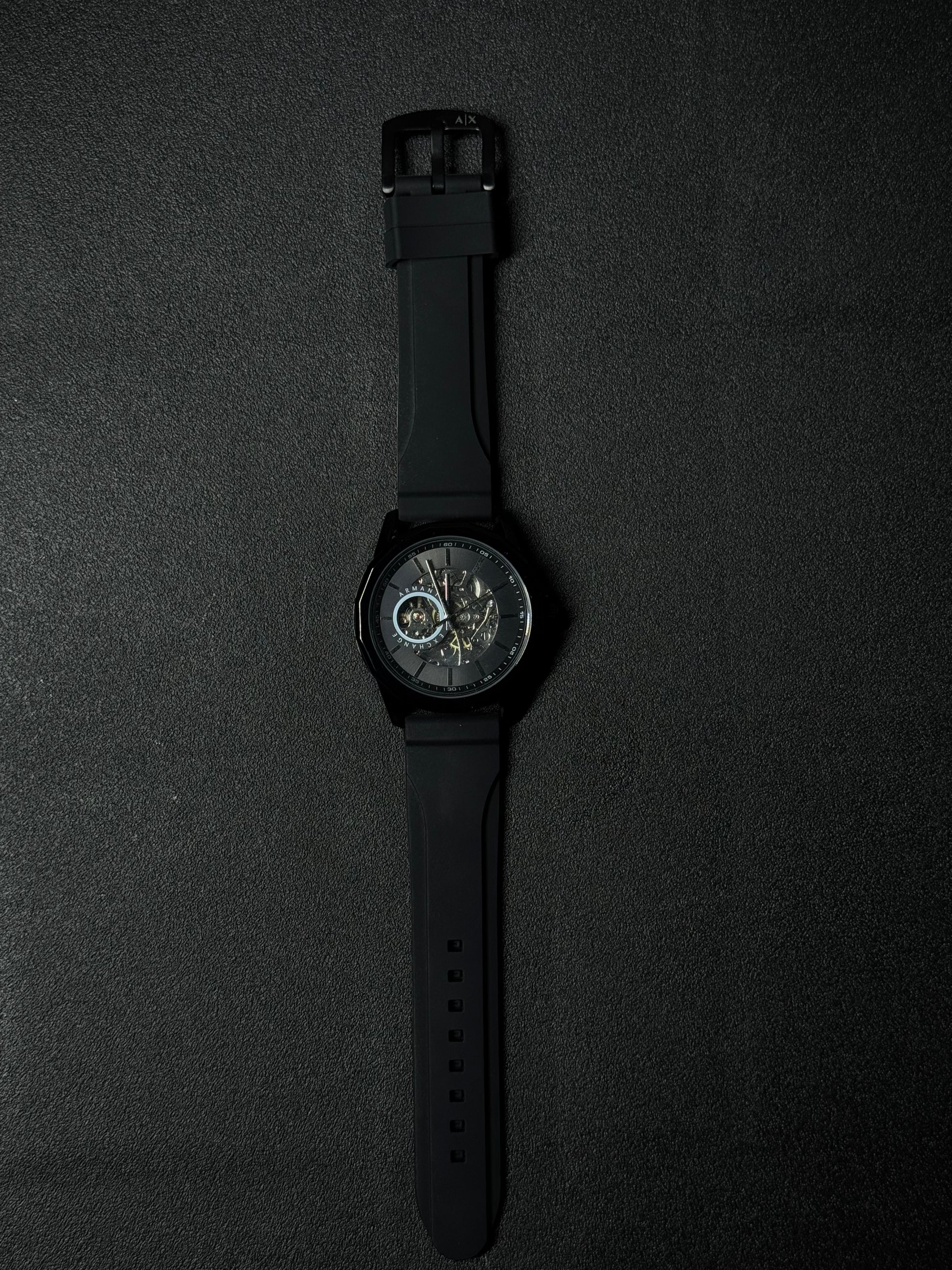 Black strap replica watch with skeleton dial, automatic-style design, premium sports wristwatch and black case finish
