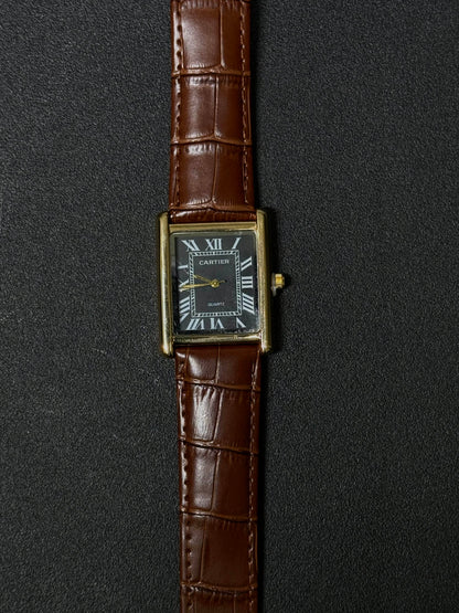 Vintage style replica watch with brown crocodile pattern leather strap, black rectangular dial, Roman numeral markers and gold-tone case