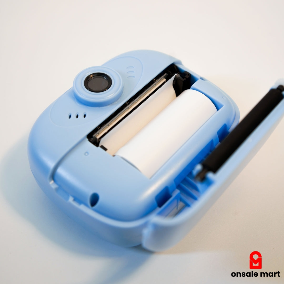 Kids instant camera opened showing built-in print paper roll.