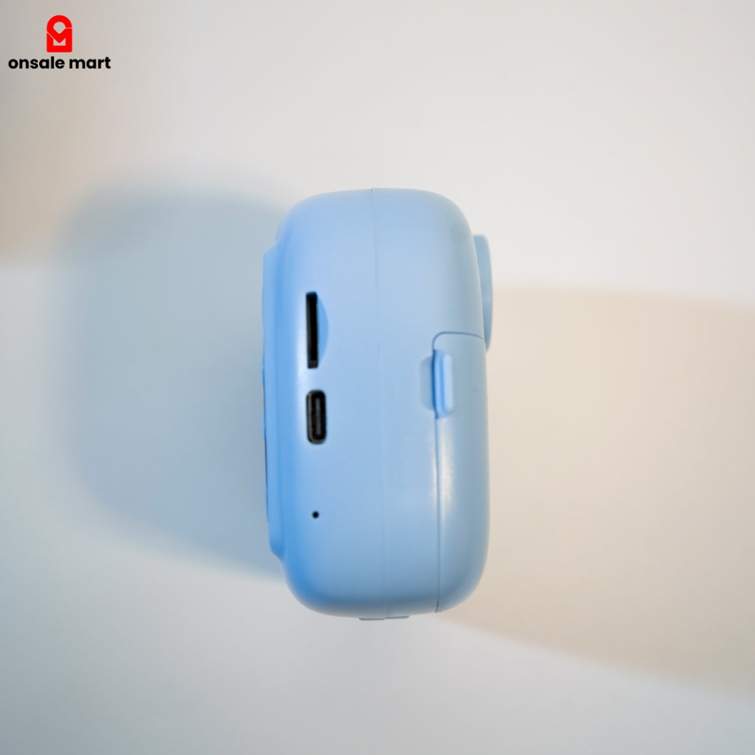Side view of kids instant camera with charging port and memory slot.