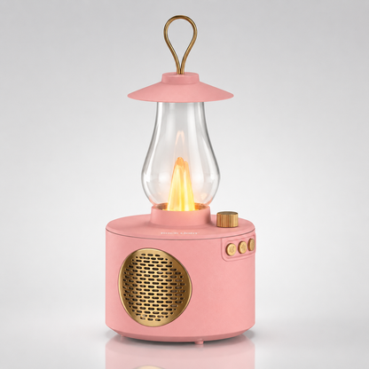Portable vintage lantern Bluetooth speaker with warm LED flame lamp, gold speaker grille, rotary volume knob, control buttons, rechargeable battery, and hanging loop on a clean studio background.