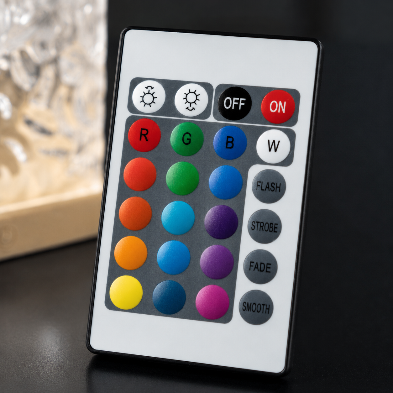 Close-up of remote control for Ocean Aura LED Night Lamp with 16 color RGB lighting modes and brightness settings