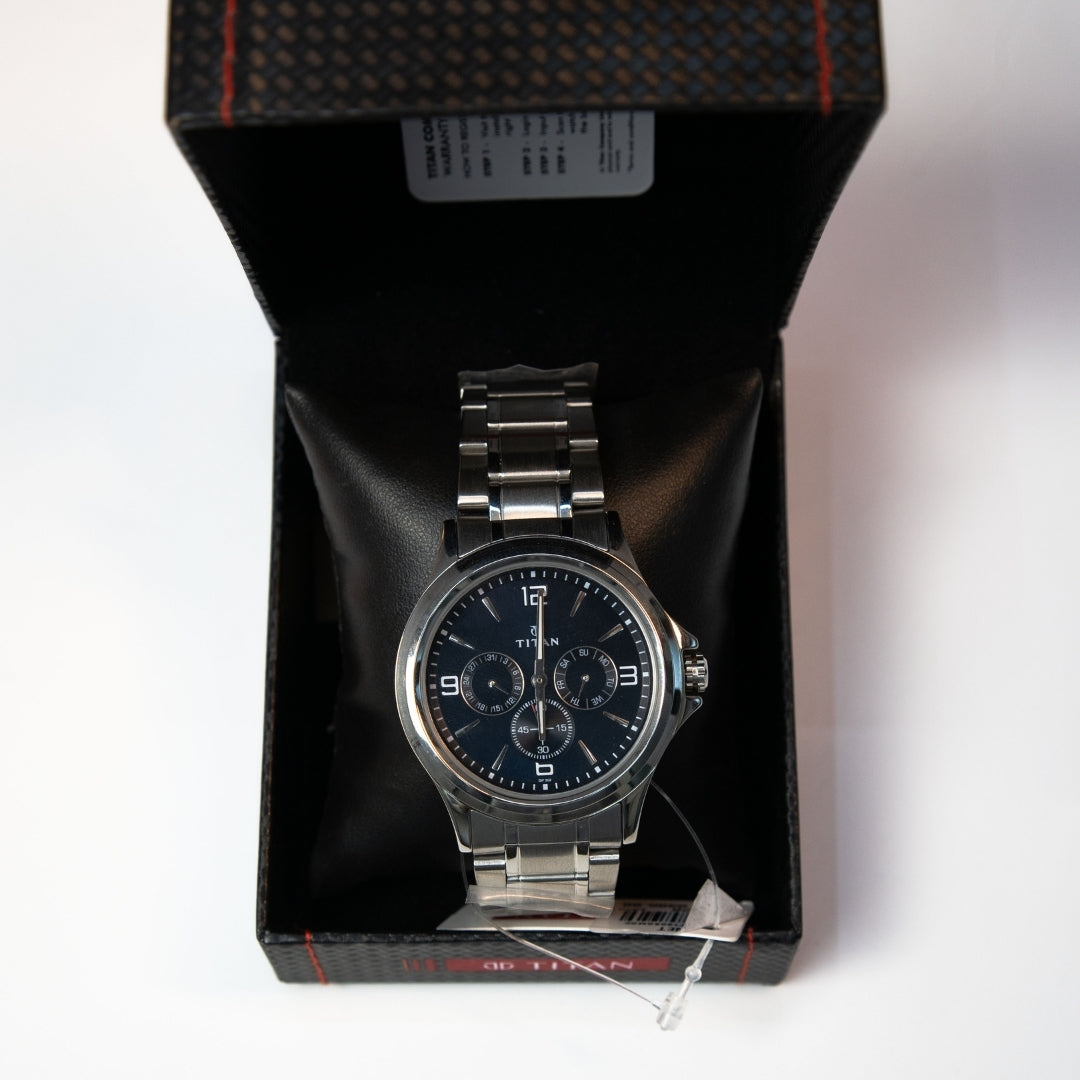 Men’s black dial multi function watch with stainless steel bracelet displayed in box.