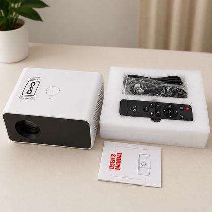 Portable LED video projector with remote control, power cable, and user manual displayed on a clean tabletop. Compact white HD projector with accessories included for home entertainment and presentations.