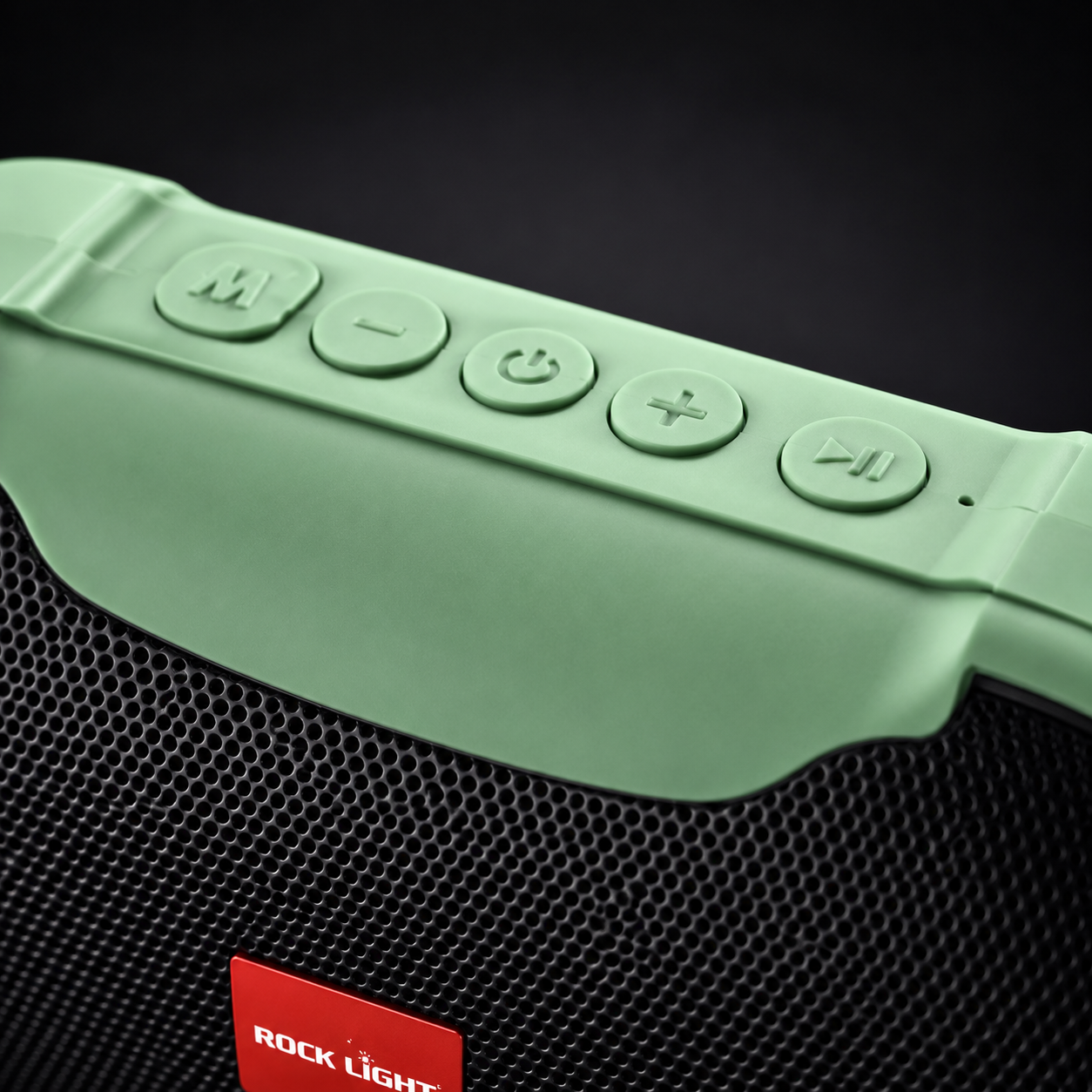 Macro shot of Rock Light Magic S156 wireless speaker control panel featuring mode, volume, power, and playback buttons on a green portable Bluetooth speaker.