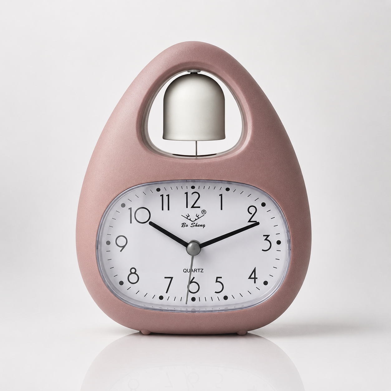 Dusty pink quartz alarm clock featuring a single bell design, easy-read analog display, and modern Nordic-style tabletop appearance.