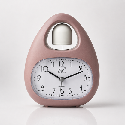 Dusty pink quartz alarm clock featuring a single bell design, easy-read analog display, and modern Nordic-style tabletop appearance.