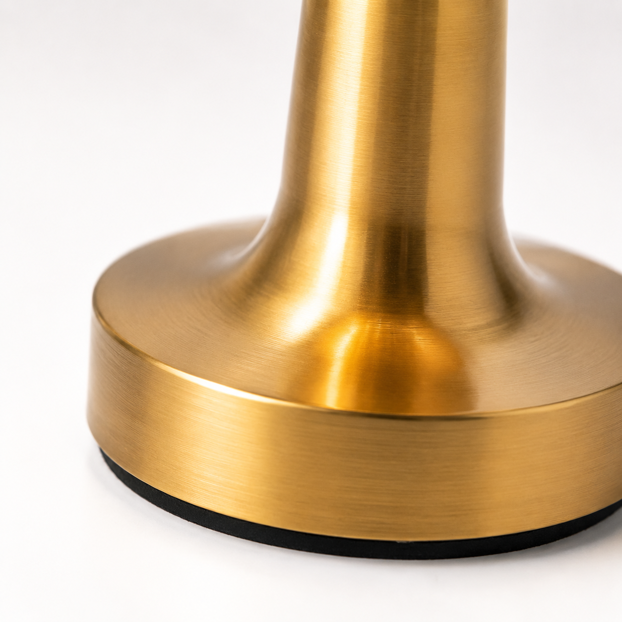 Close-up view of aluminum alloy LED lamp base with elegant brushed metal texture and stable round design