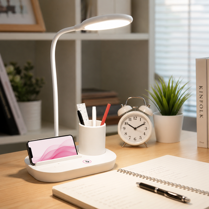 Modern rechargeable LED desk lamp with integrated pen holder and phone stand on a study desk, providing soft adjustable lighting for reading, studying, and office work.