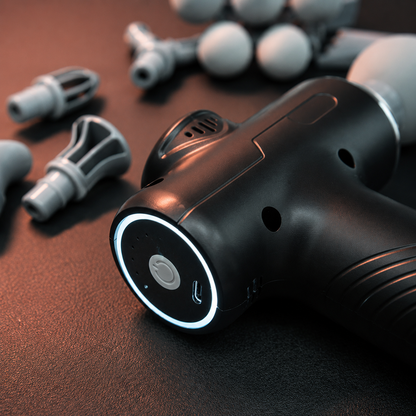 Close-up view of Multi-Head Percussion Massage Gun showing LED indicator ring, USB charging port, ventilation system and premium ergonomic body design.
