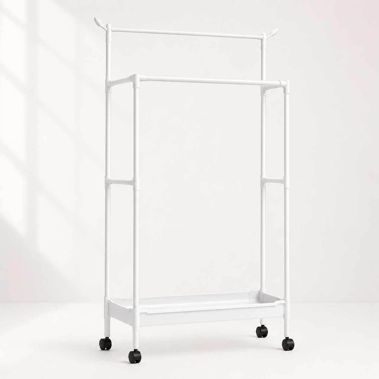 White multipurpose clothes and shoe storage rack with double hanging poles, bottom storage shelf, caster wheels, space-saving garment organizer for bedroom and laundry room