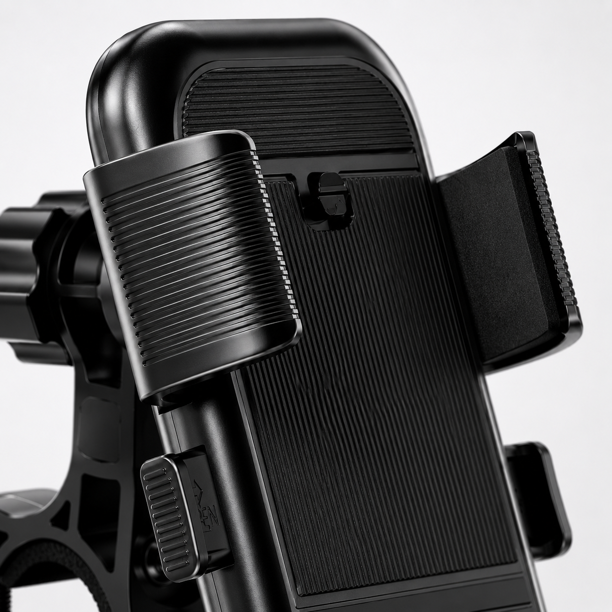 Macro view of the semi-automatic side clamps with textured grip and silicone padding, designed to securely hold smartphones during motorcycle and bicycle rides.