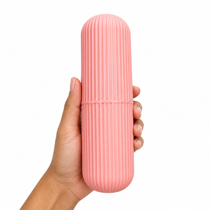 Pink travel toothbrush storage case held in hand, lightweight portable toothbrush holder with ribbed anti-slip design