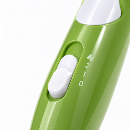 Close-up of portable hair dryer's control panel showing on/off switch with two speed settings and airflow selector on a compact foldable handle.