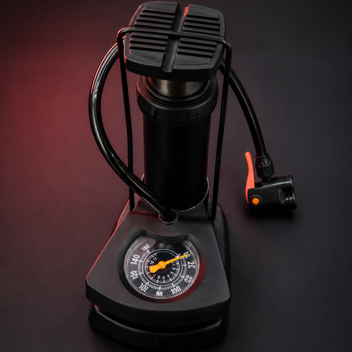 Portable Mini Foot Pump with Built-In Pressure Gauge and Compact Foldable Design on Dark Background