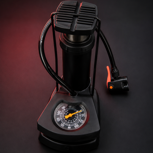 Portable Mini Foot Pump with Built-In Pressure Gauge and Compact Foldable Design on Dark Background