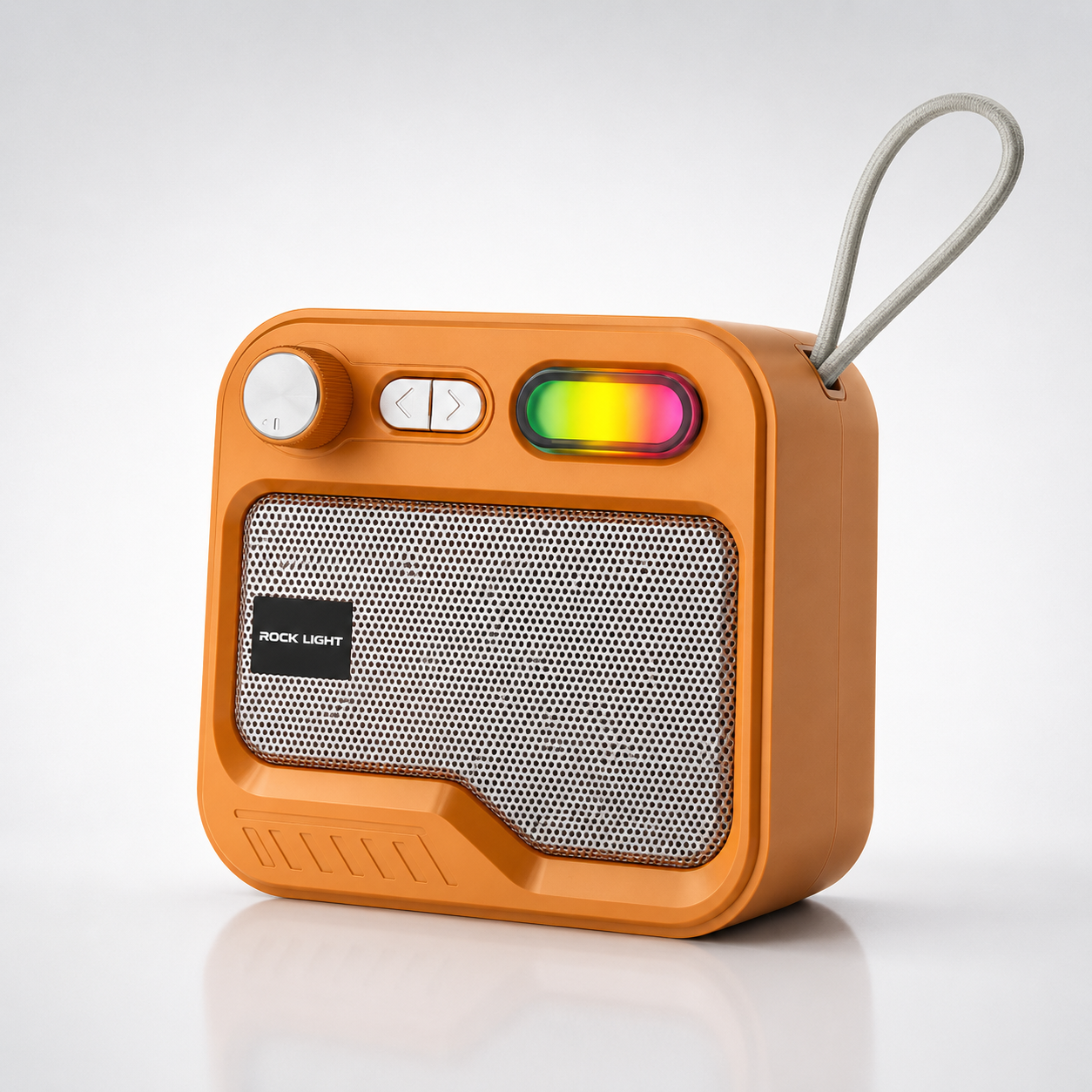 Orange portable Bluetooth speaker with metal mesh grille, rotary control knob, RGB lighting element, built-in carry strap, rechargeable battery, and compact retro-style design
