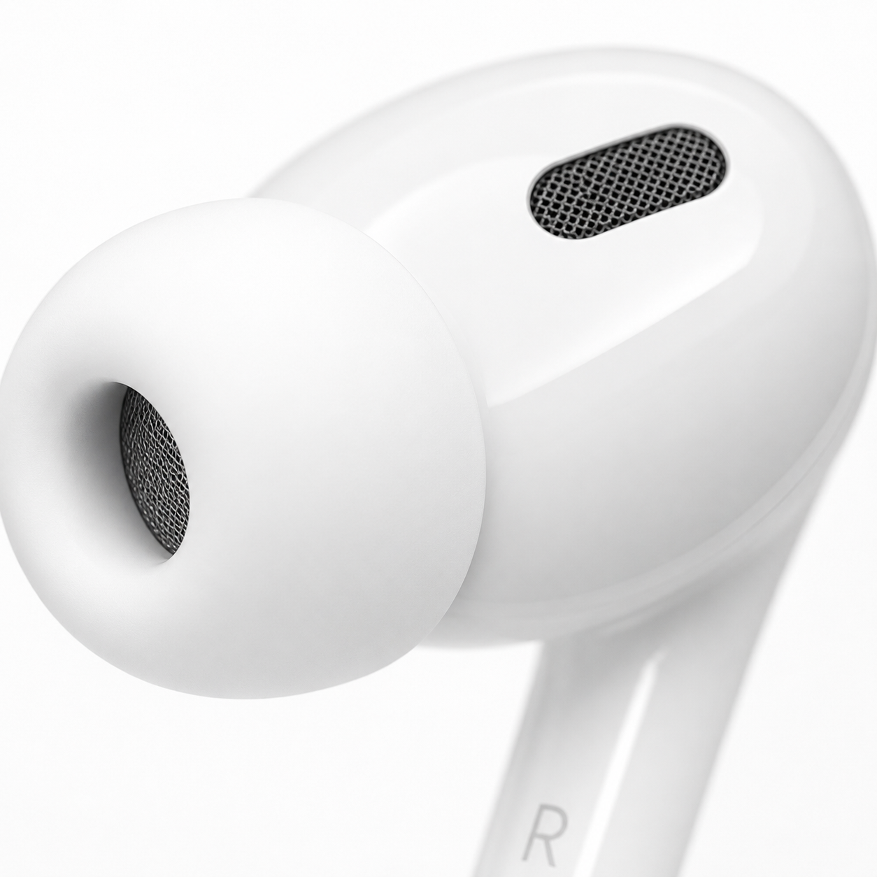 Extreme close-up of a white in-ear wireless earbud with soft silicone ear tip, precision speaker mesh, and ergonomic design for comfortable all-day wear.