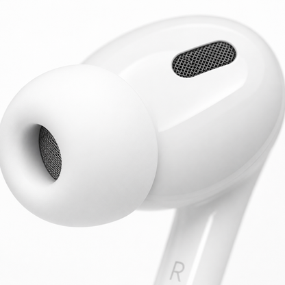 Extreme close-up of a white in-ear wireless earbud with soft silicone ear tip, precision speaker mesh, and ergonomic design for comfortable all-day wear.
