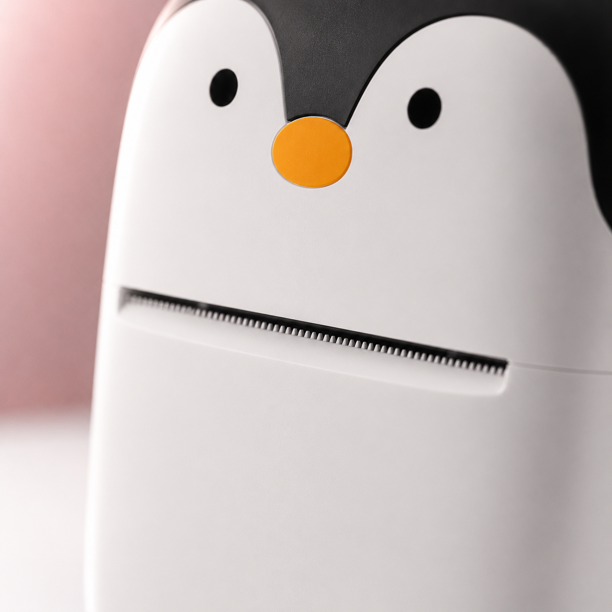 Close-up macro view of the portable thermal mini printer highlighting the precision thermal print head and cute penguin-inspired front design with a smooth matte finish.