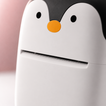 Close-up macro view of the portable thermal mini printer highlighting the precision thermal print head and cute penguin-inspired front design with a smooth matte finish.