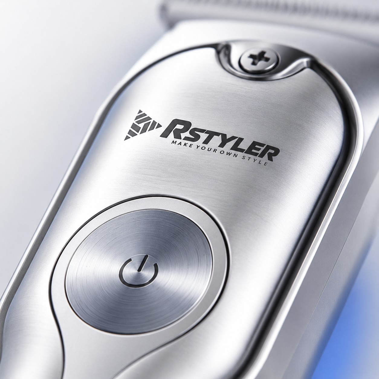Close-up macro view of a professional cordless hair trimmer featuring a brushed metal body, precision power button, stainless steel finish, and premium grooming design.