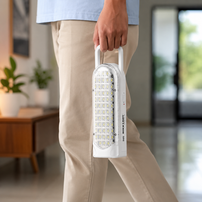 Person carrying a rechargeable 56 SMD LED emergency light by its built-in handle, highlighting its lightweight portable design for home, travel, camping, and emergency use.