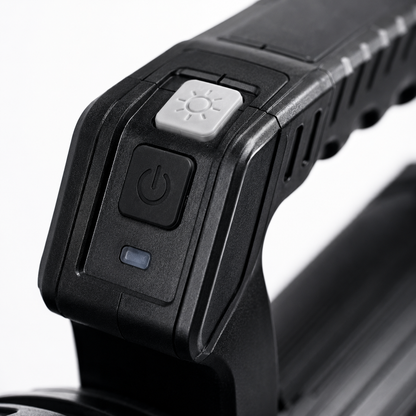 Close-up of the rechargeable LED searchlight handle featuring the power button, lighting mode switch, battery indicator and ergonomic textured grip.
