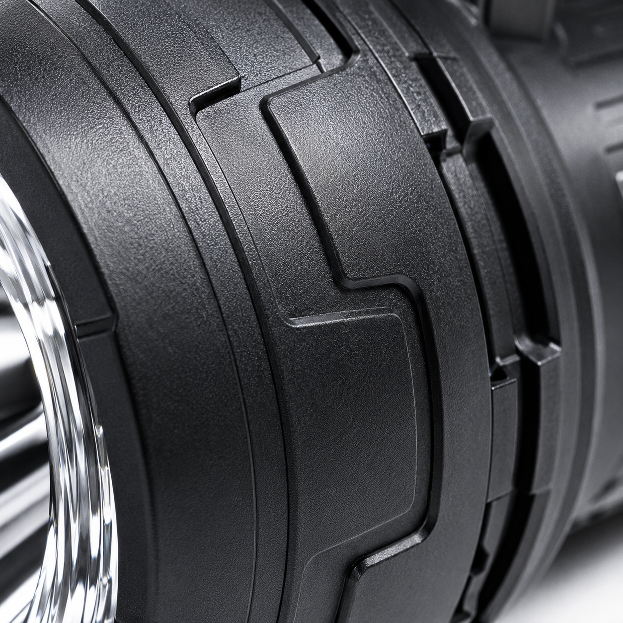 Close-up of the rechargeable LED searchlight handle featuring the power button, lighting mode switch, battery indicator and ergonomic textured grip.