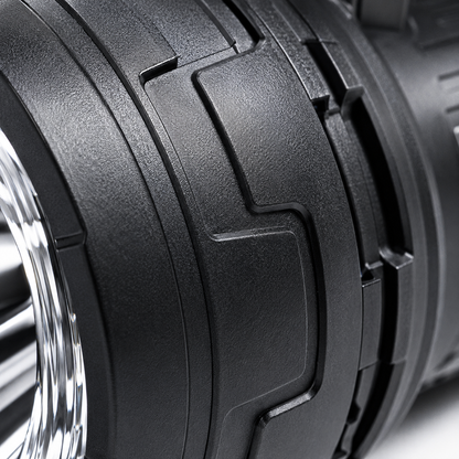 Close-up of the rechargeable LED searchlight handle featuring the power button, lighting mode switch, battery indicator and ergonomic textured grip.