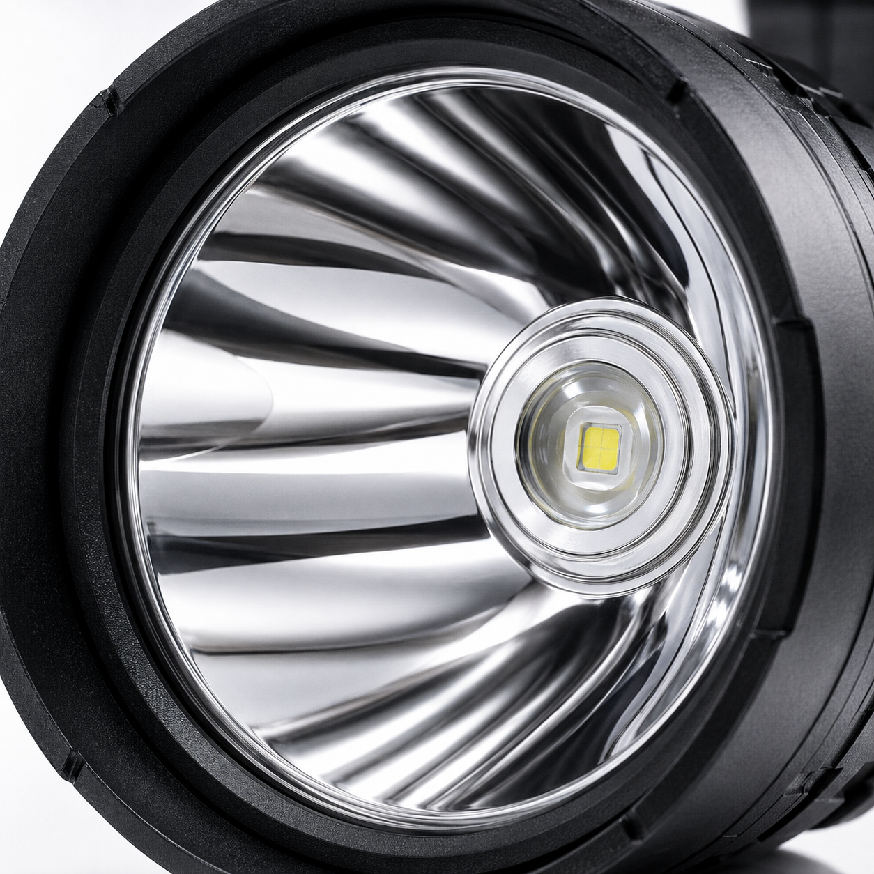 Close-up of the high-power LED emitter and polished aluminium reflector inside the rechargeable searchlight, designed for focused long-range illumination.
