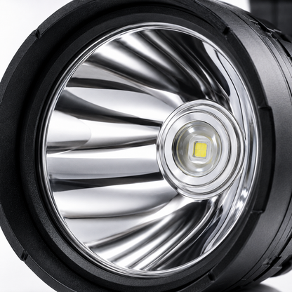 Close-up of the high-power LED emitter and polished aluminium reflector inside the rechargeable searchlight, designed for focused long-range illumination.