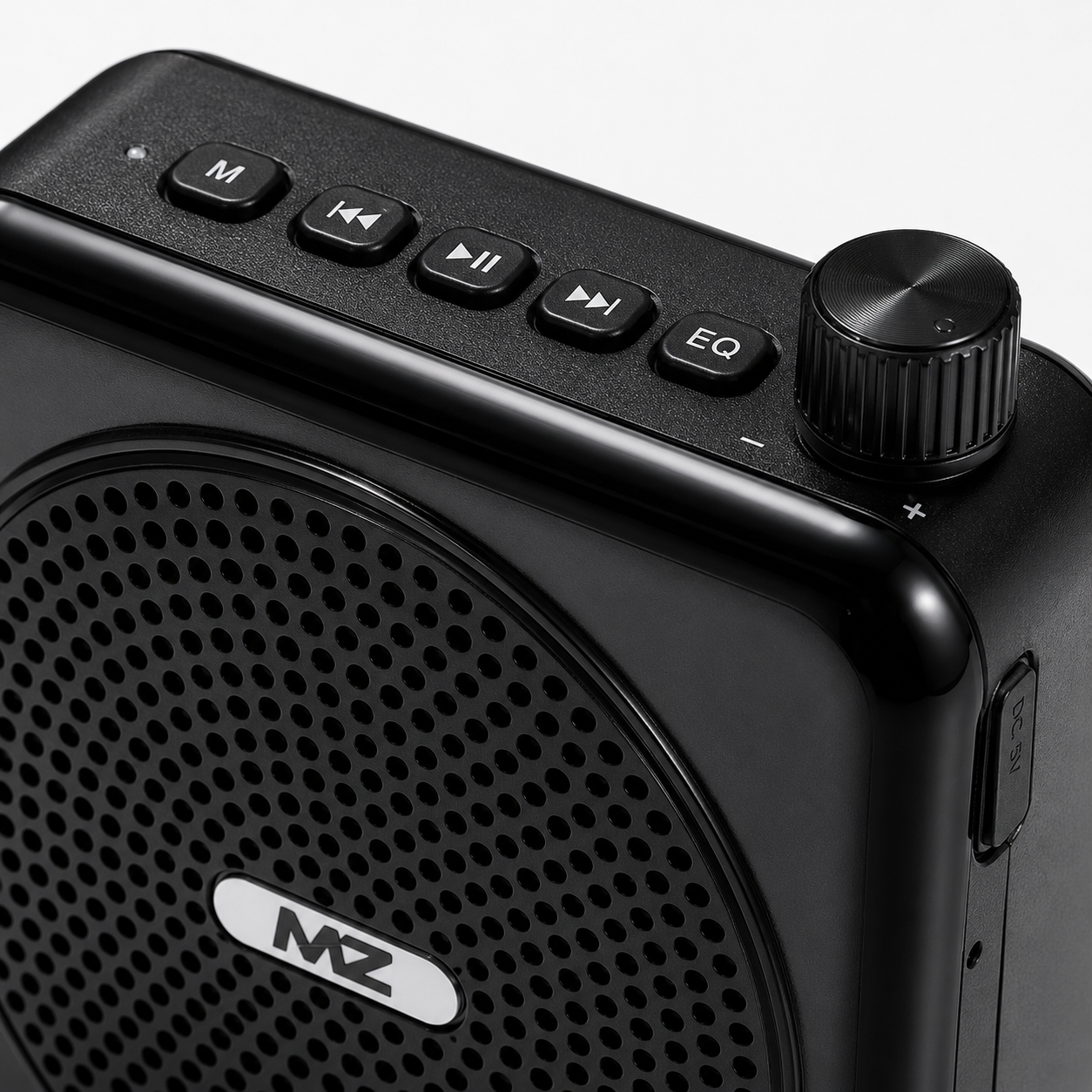 Close-up of portable voice amplifier featuring volume control knob, playback buttons, EQ button, USB charging port and durable textured finish.