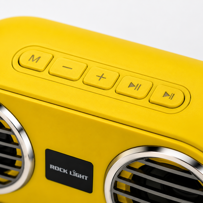 Macro close-up of the top control panel showing mode, volume down, volume up, play/pause and track control buttons on the yellow portable Bluetooth karaoke speaker.