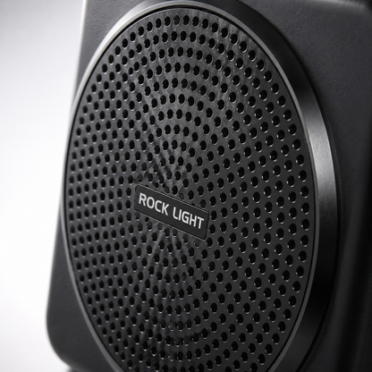 Close-up of a portable wireless voice amplifier featuring a perforated front speaker grille with a durable matte black finish, designed to deliver clear and powerful sound for teaching, presentations, and public speaking.