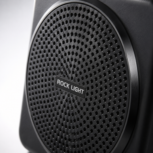Close-up of a portable wireless voice amplifier featuring a perforated front speaker grille with a durable matte black finish, designed to deliver clear and powerful sound for teaching, presentations, and public speaking.