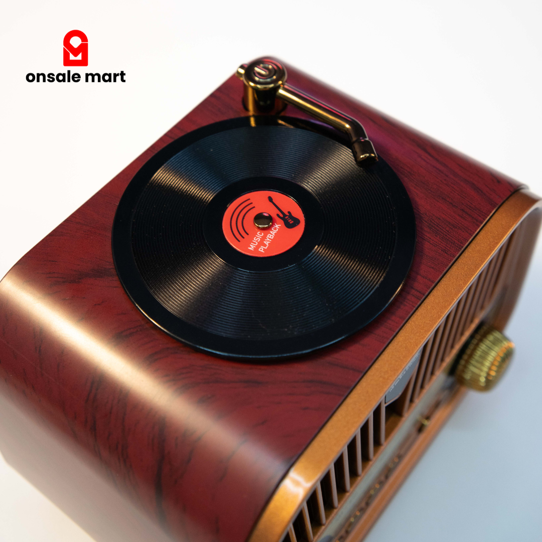 Retro style portable wireless speaker with record player design and control knobs on top.