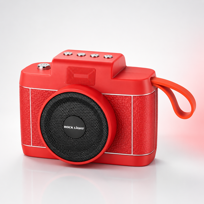 Front three-quarter view of the Rock Light Shoot S169 wireless Bluetooth speaker featuring a retro camera-inspired design, powerful front speaker grille, integrated carry strap, compact portable body, and premium red finish