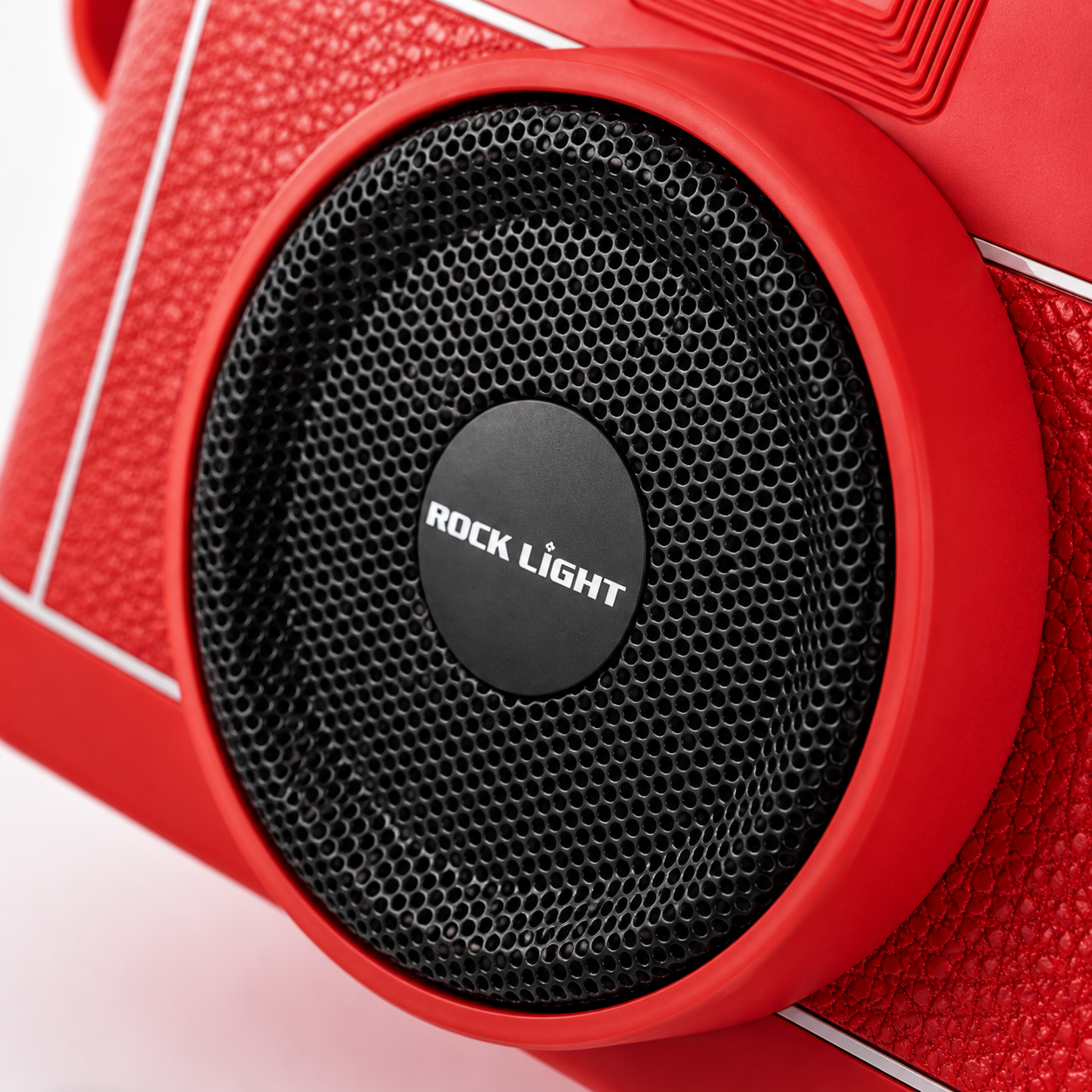 Macro product photography highlighting the Rock Light Shoot S169 speaker grille with precision metal mesh, central Rock Light logo, textured red camera-style housing, and premium build quality