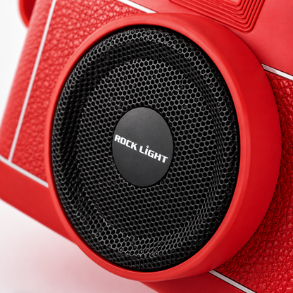 Macro product photography highlighting the Rock Light Shoot S169 speaker grille with precision metal mesh, central Rock Light logo, textured red camera-style housing, and premium build quality